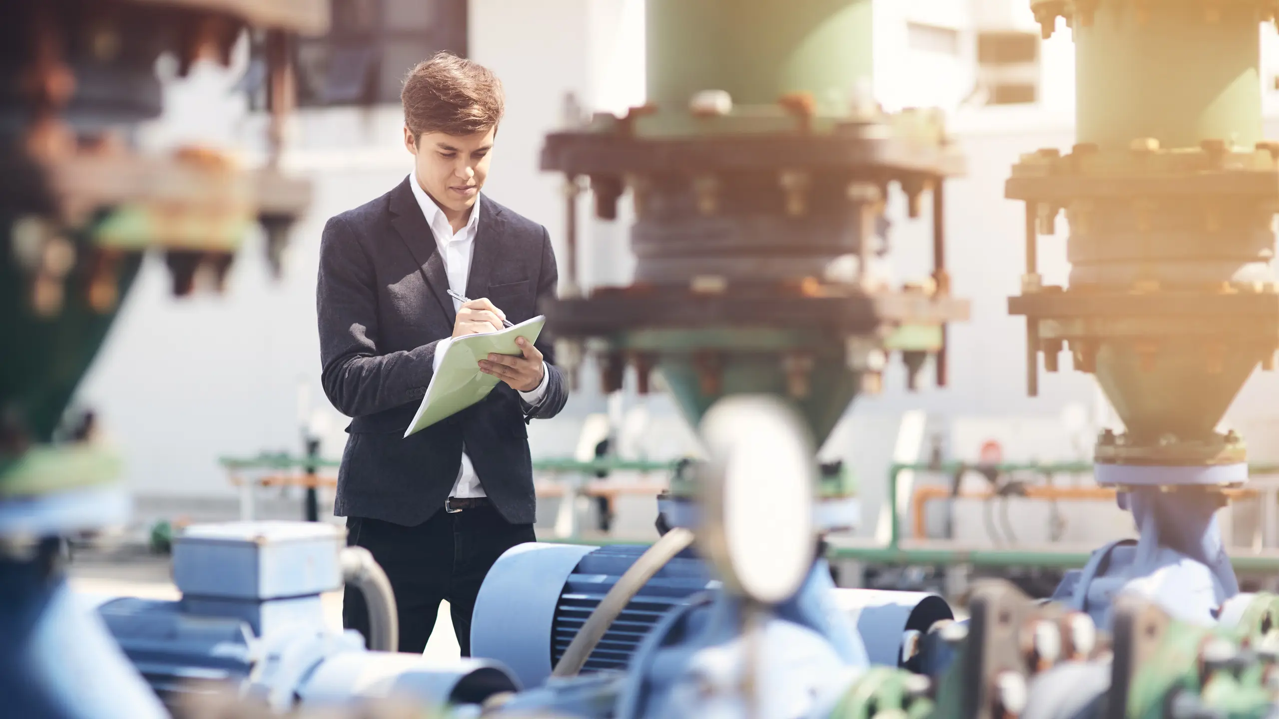A young engineer surveys pumps.